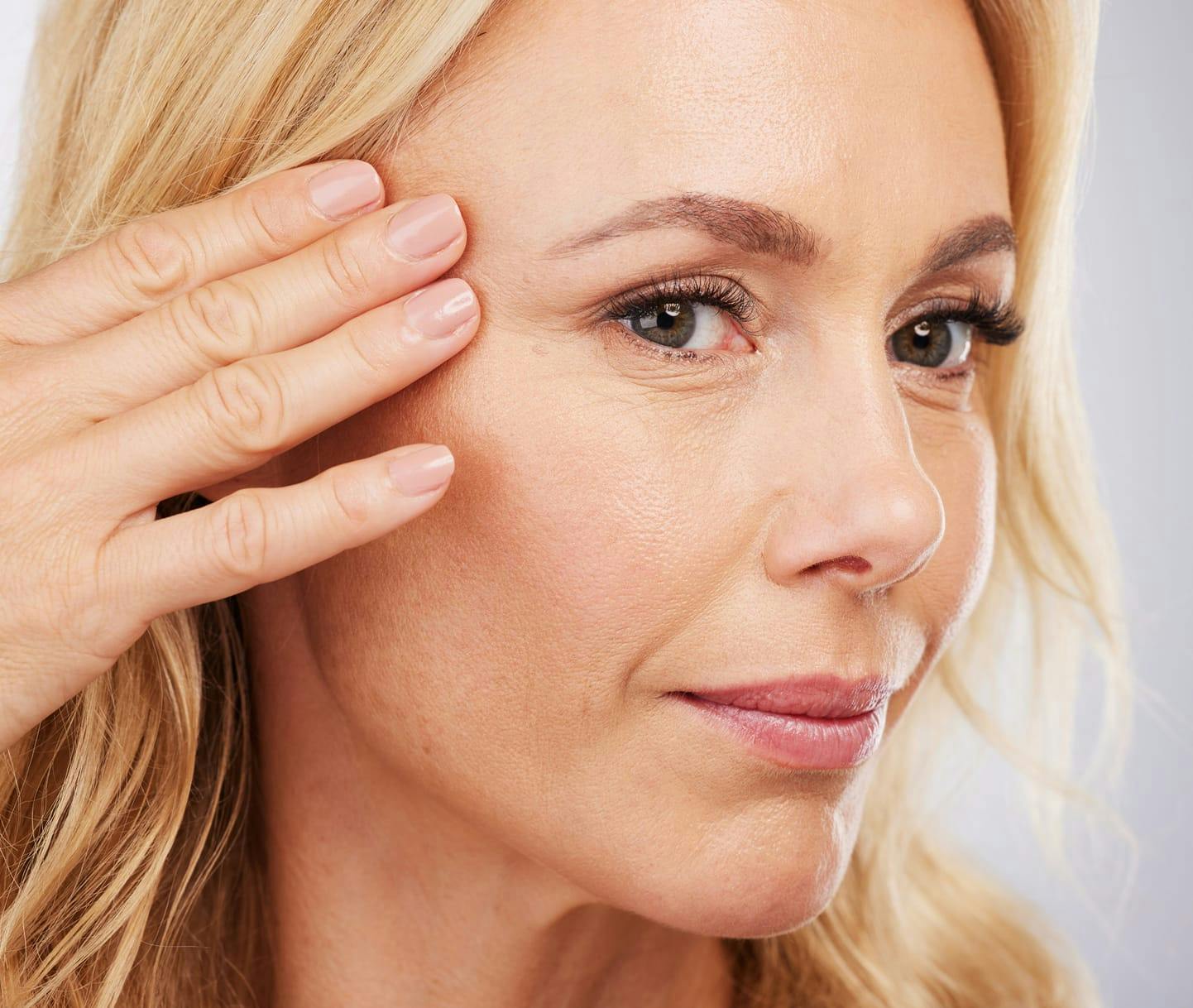 Woman touching around her eye