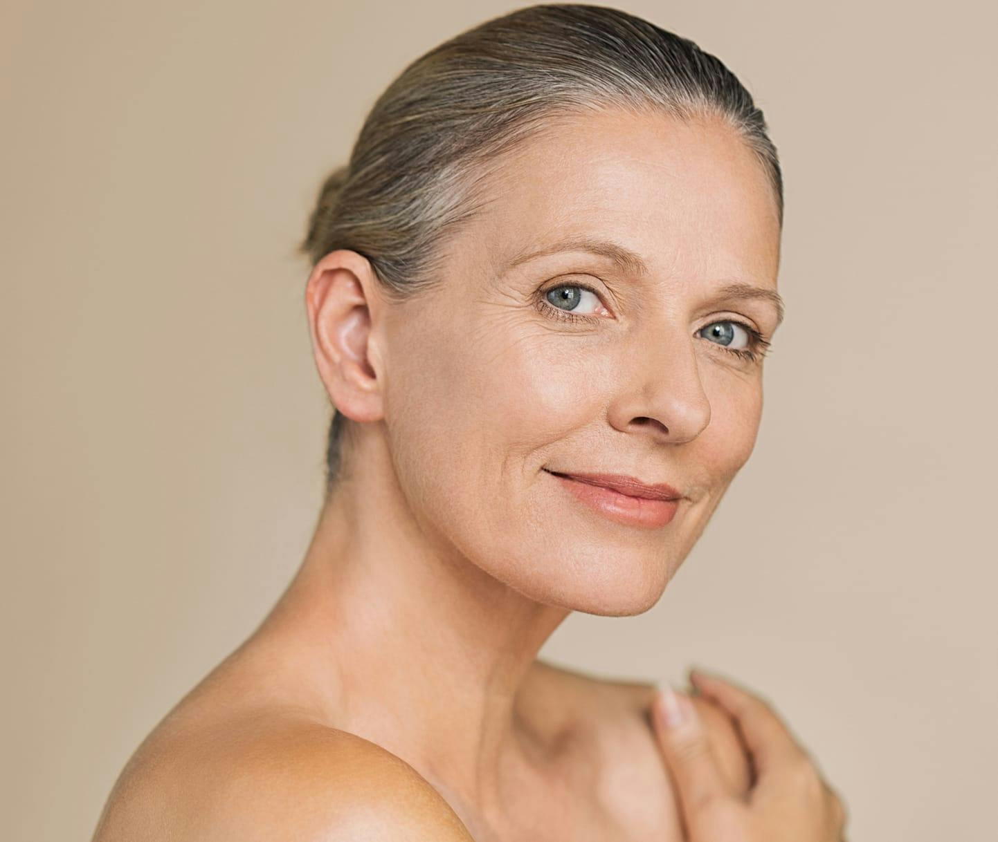 Woman smiling with hand on shoulder