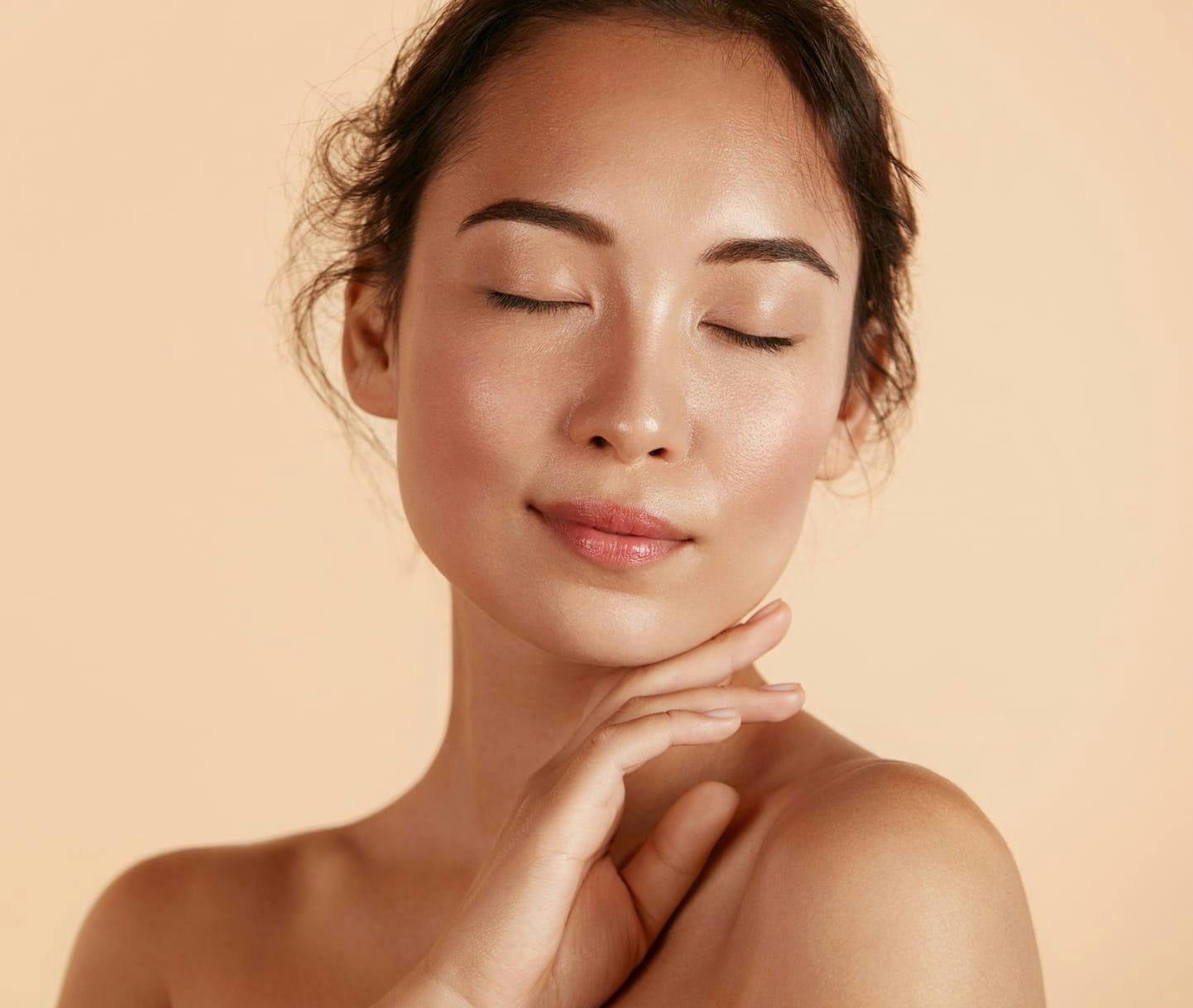 Woman with eyes closed and hand on chin