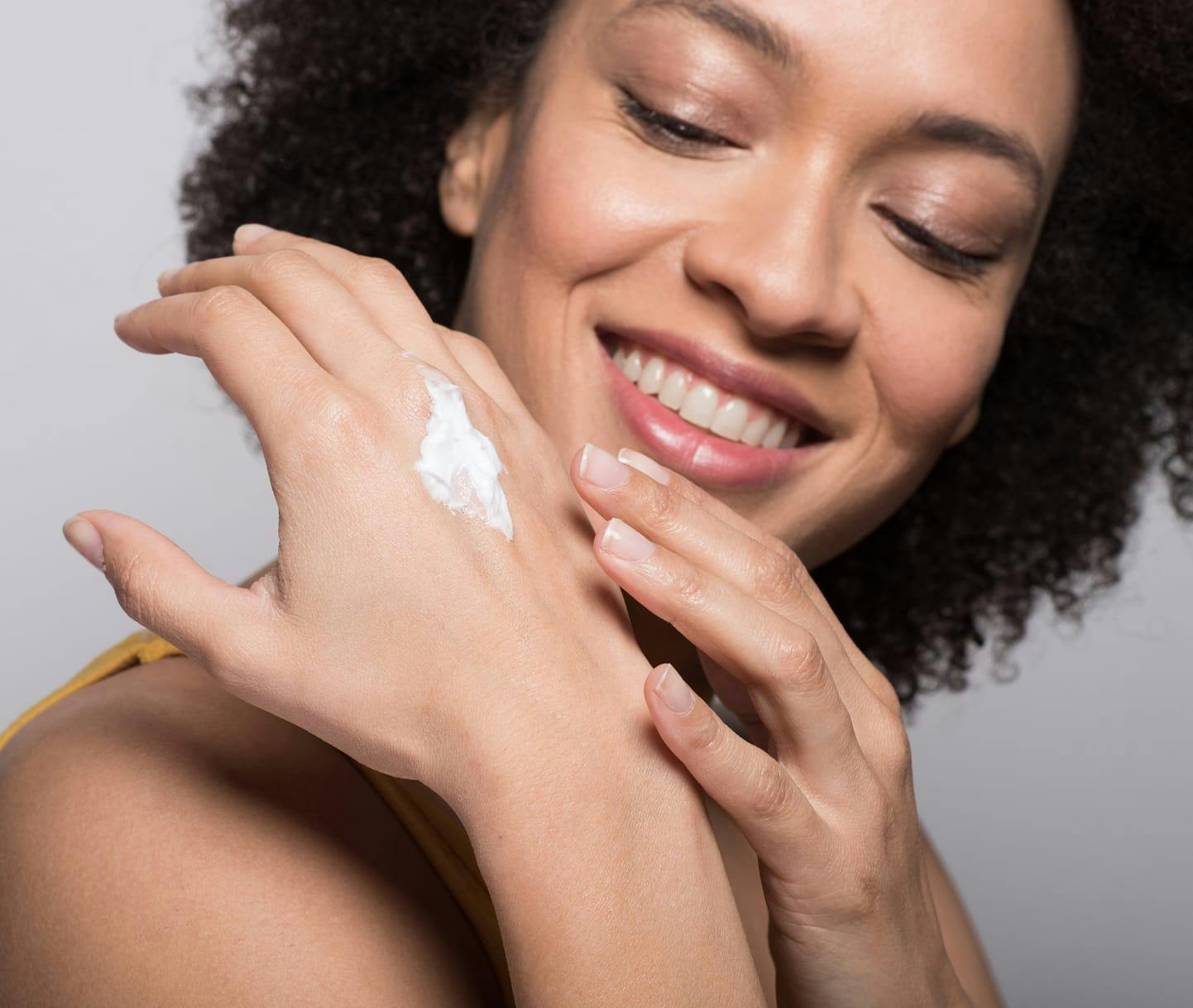 Woman rubbing lotion into hand