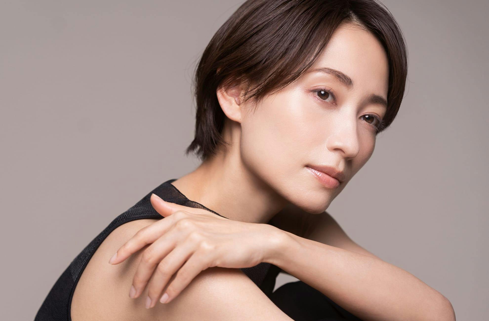 Person looking off camera touching shoulder