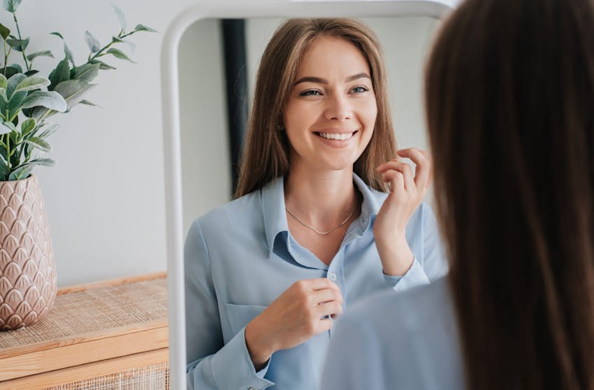 Woman smiling in a mirror
