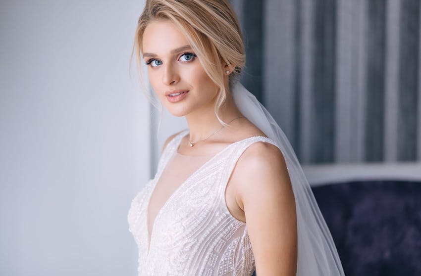 Woman in a wedding dress smiling