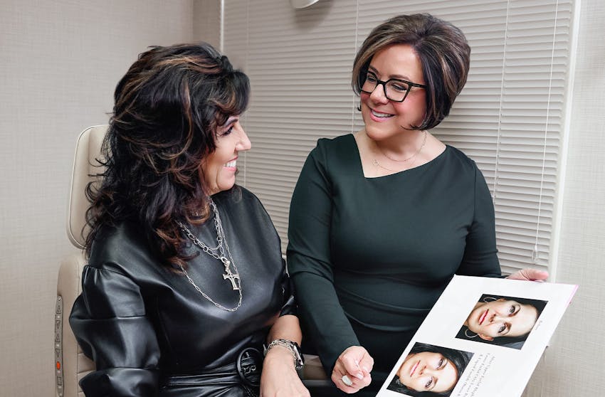 doctor showing a client a before and after of an eyelid procedure