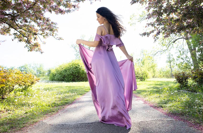 Woman in a dress walking down a path