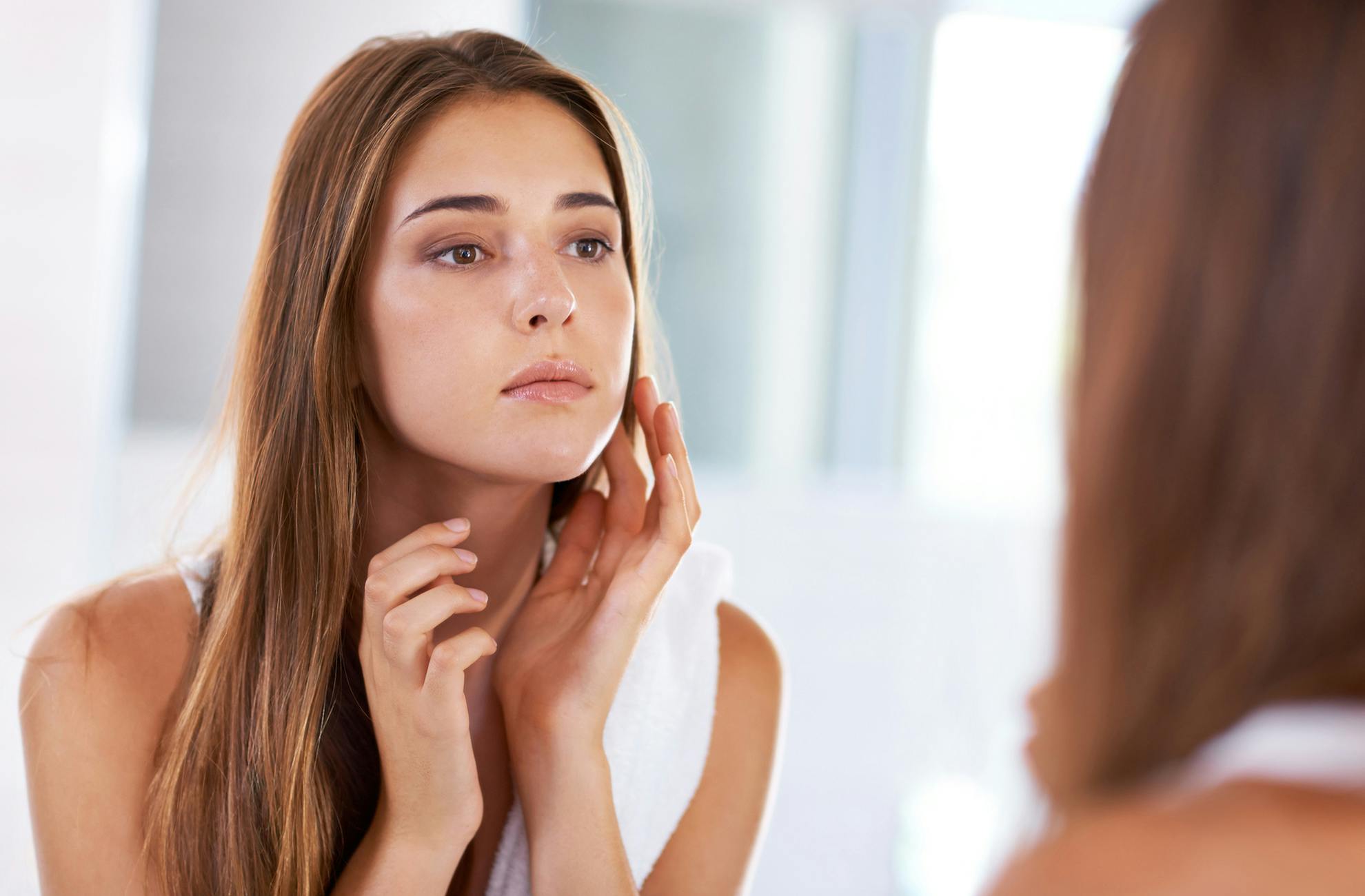 woman looking at her face