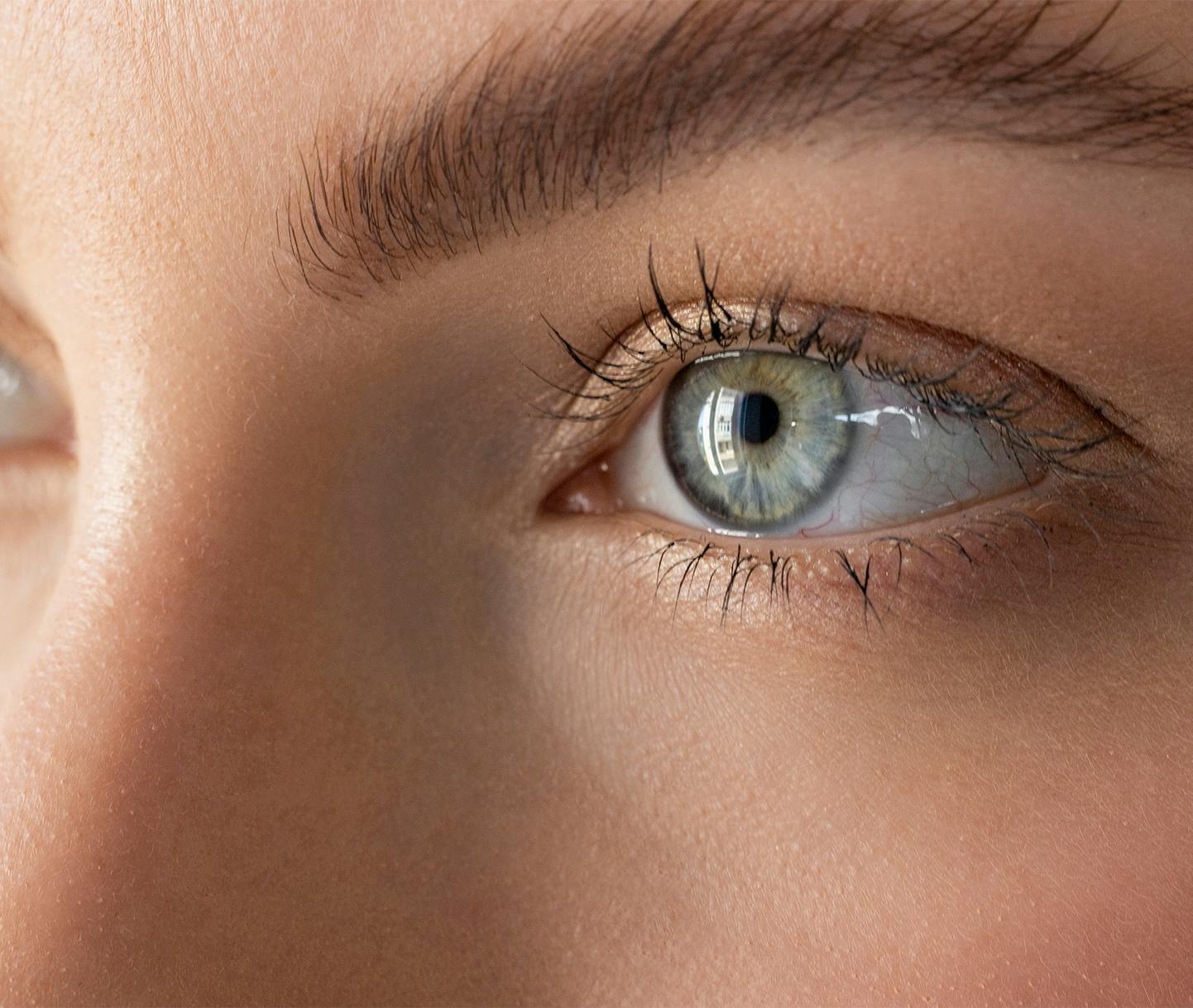woman with hoop earrings and gray sweater