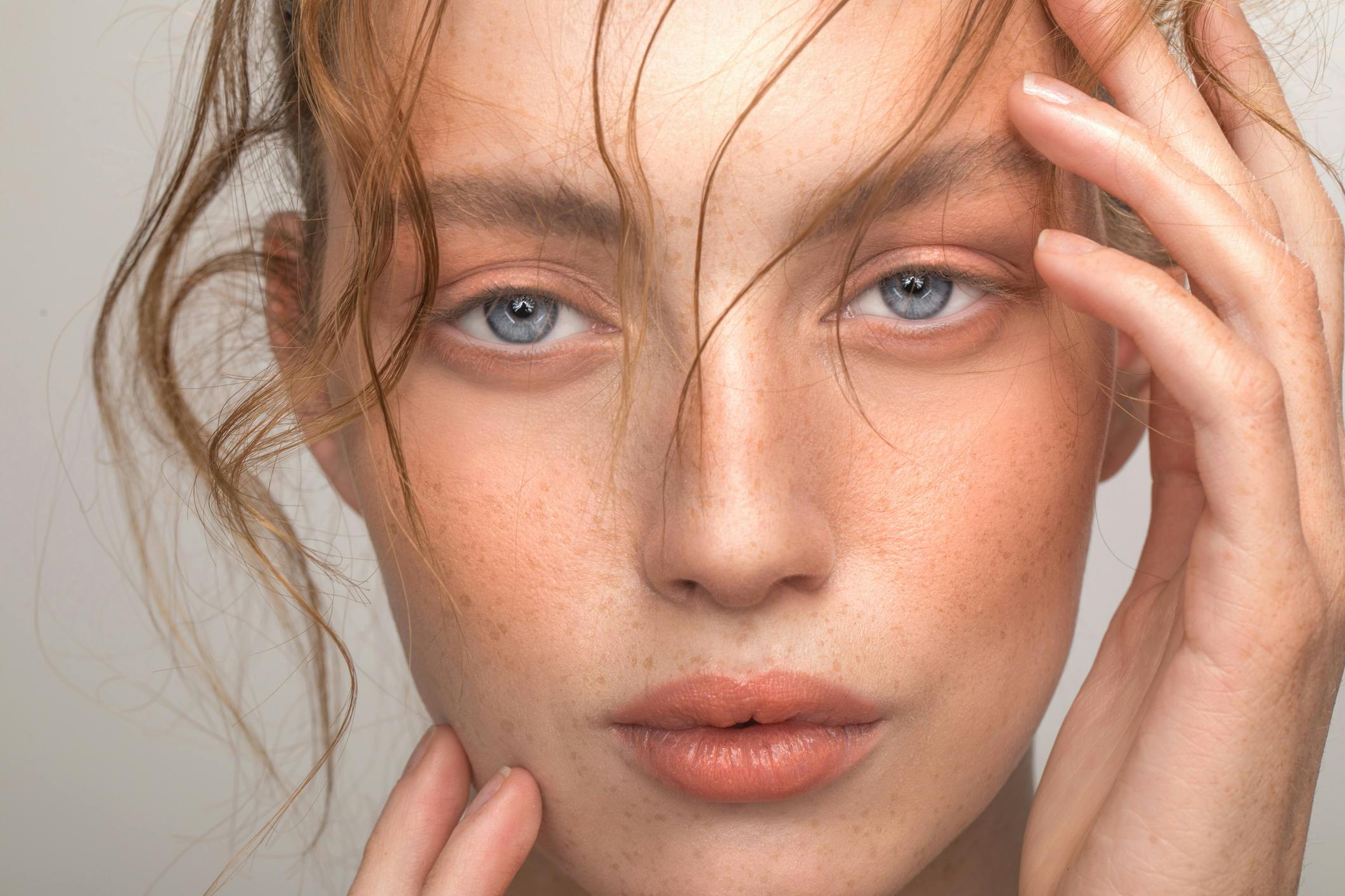 Beautiful woman with hair flowing in her face in studio shoot
