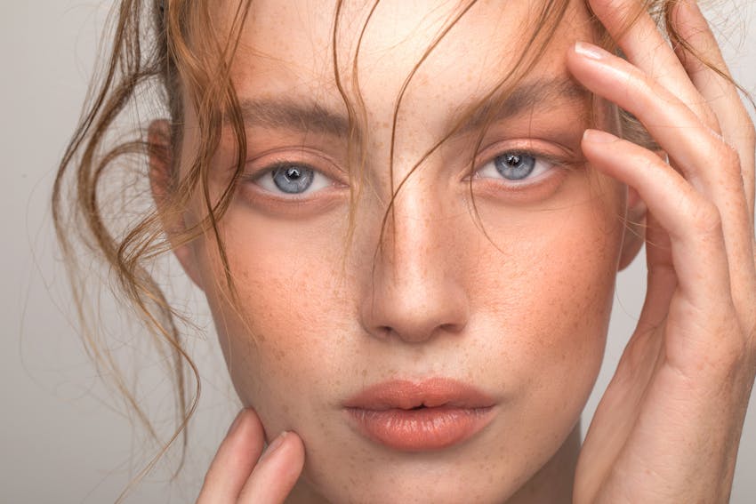 Beautiful woman with hair flowing in her face in studio shoot