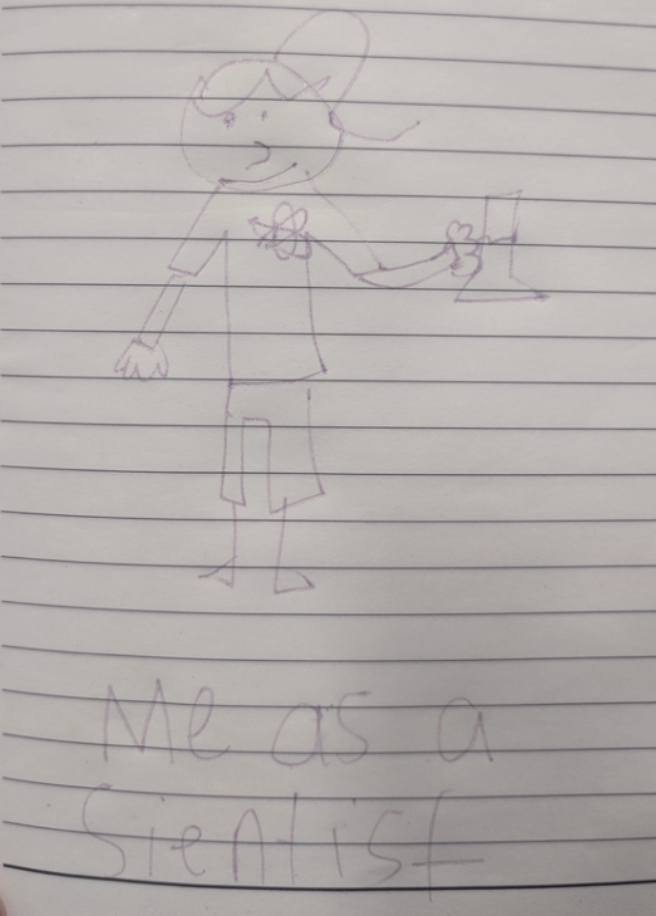 A child’s pencil drawing on lined paper shows a smiling bear or bear-like character standing upright and holding a small object in one hand. The character appears to be wearing a cap, shirt, and pants. Handwritten text at the bottom reads, “Me as a scientist.”