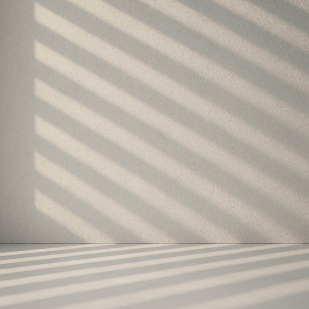 Abstract light and shadow pattern on a neutral wall.