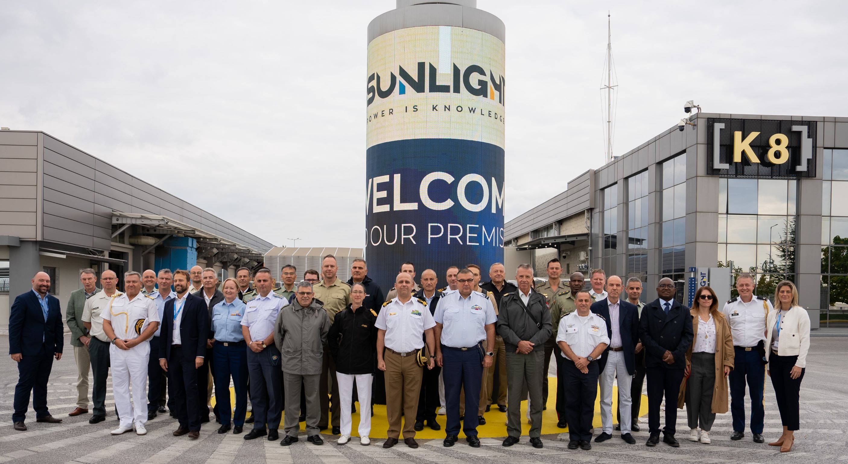 Group of officials and employees at Sunlight facility.