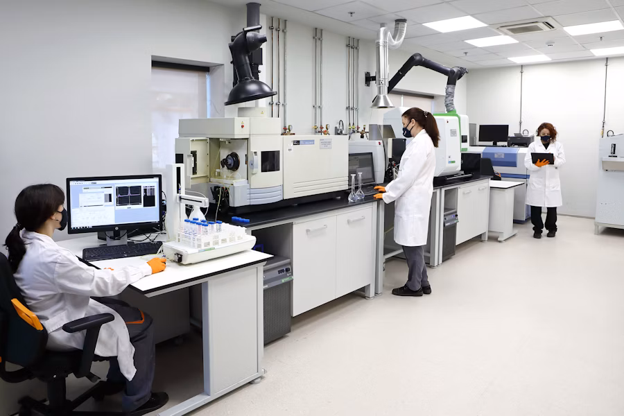 Scientists working in a modern laboratory with analytical equipment.