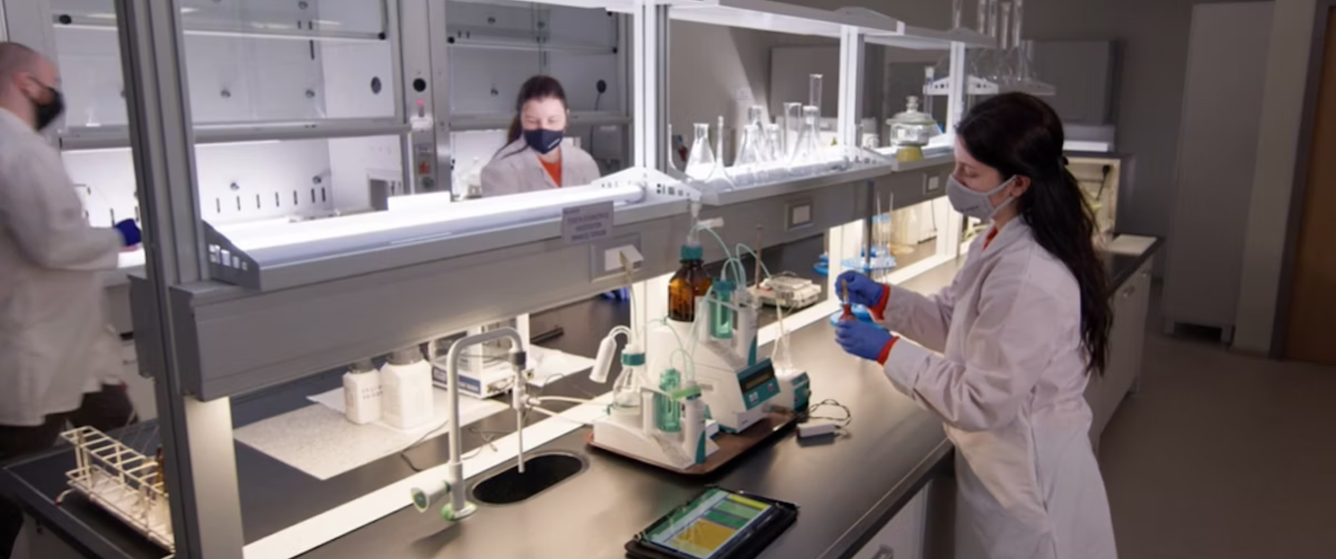 Scientists working in a modern laboratory with analytical equipment.