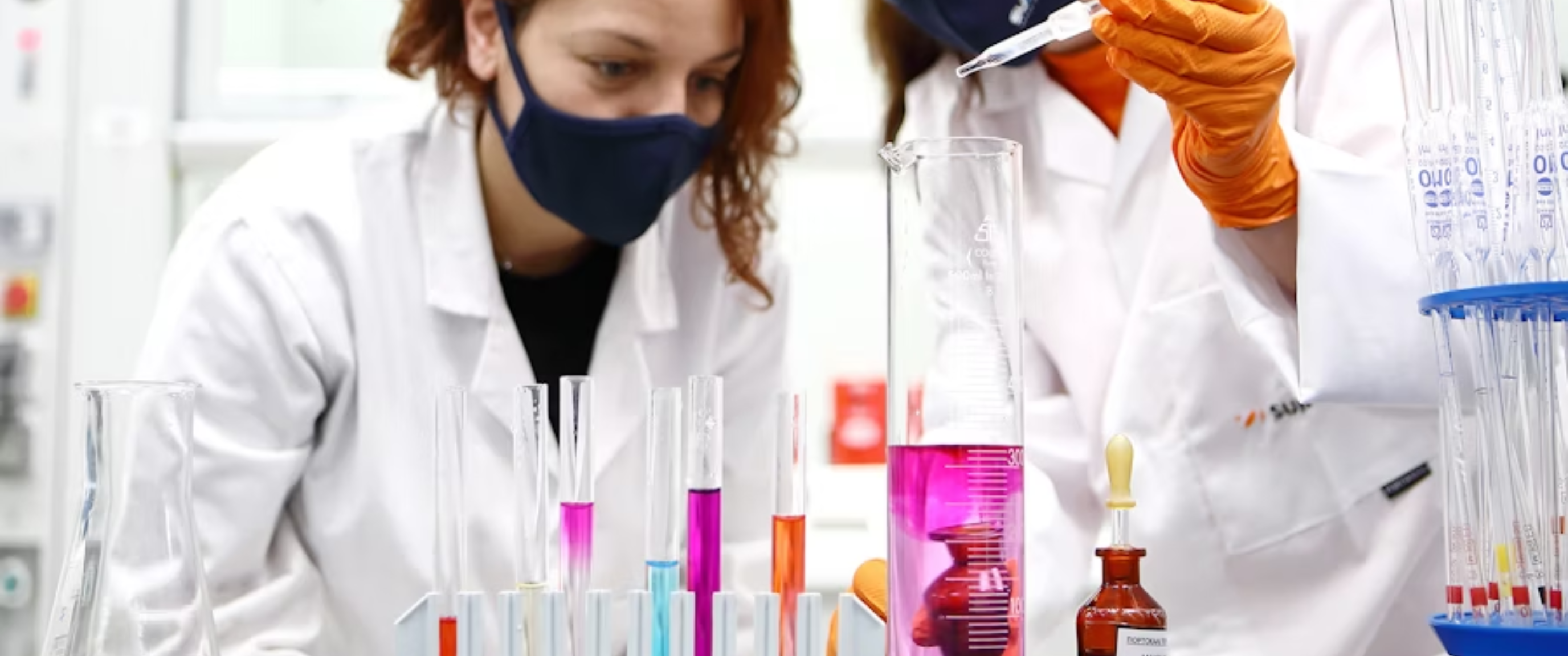 Scientists conducting laboratory experiments with test tubes.