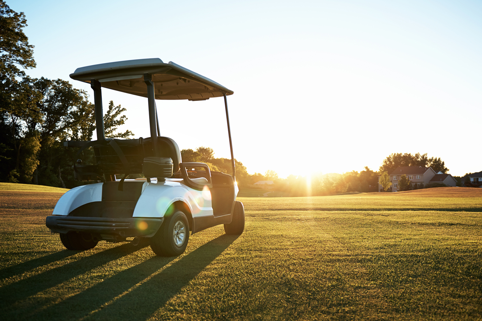 TRI Golf cart on field at sunset