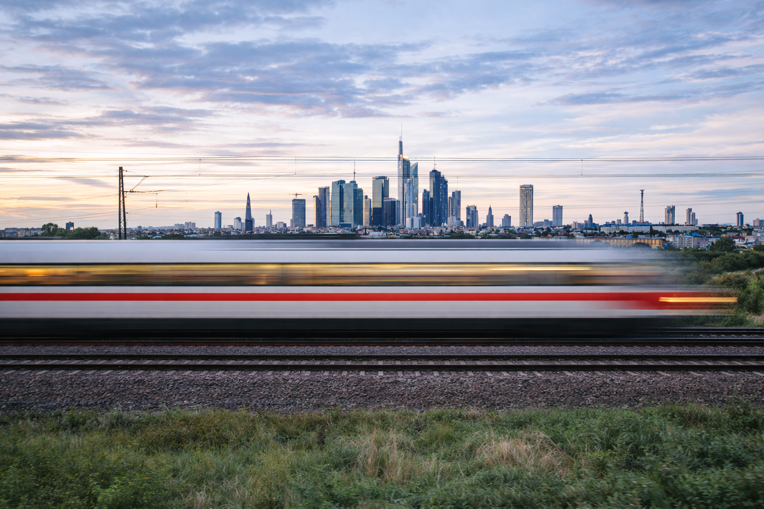 Train tracks inside a modern rail structure with motion blur, symbolizing speed and energy efficiency