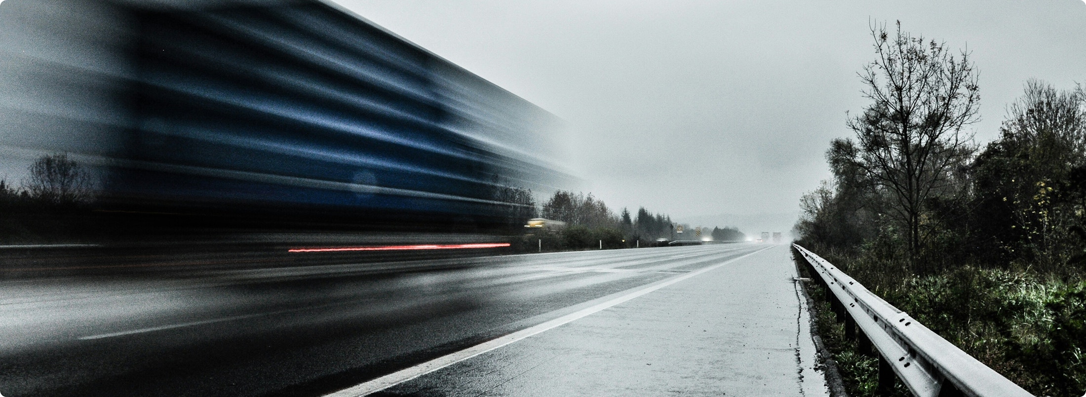 Image of a vehicle moving quickly down a highway