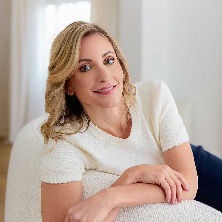 Sara Nichols leaning on a couch