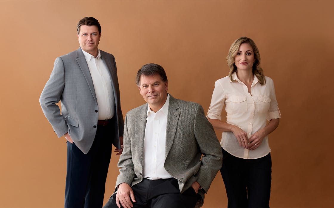 The Lawyers against brown backdrop