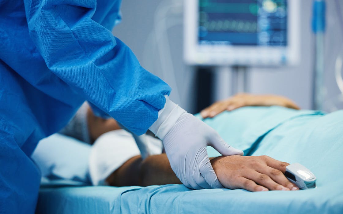 Doctor touching patients hand