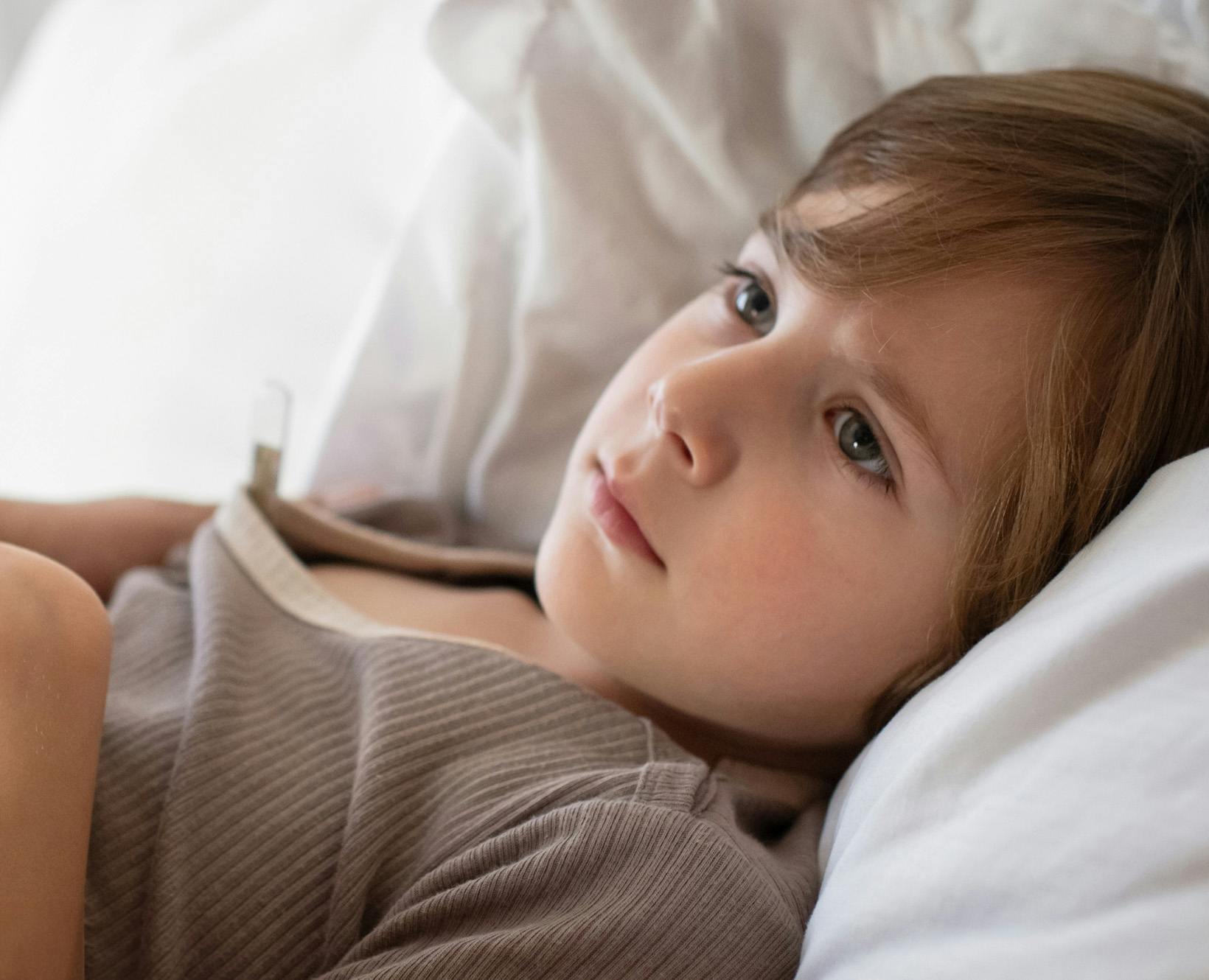 A kid staring up at the ceiling