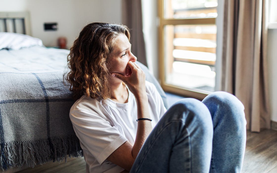 Woman sitting on the floor upset