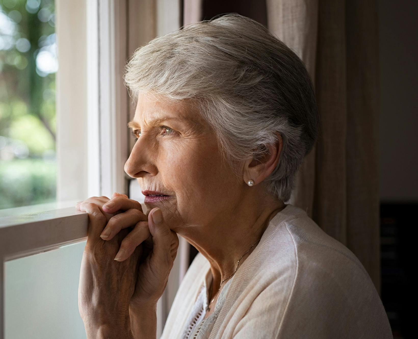 older lady looking out the window