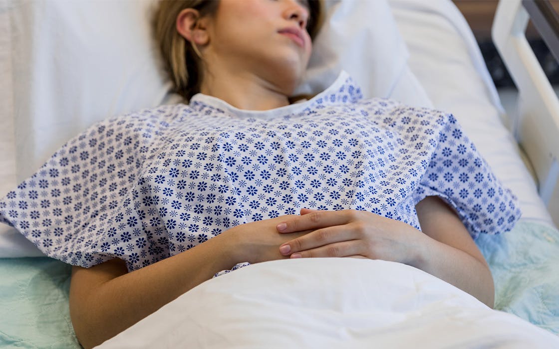 Woman laying on hospital bed