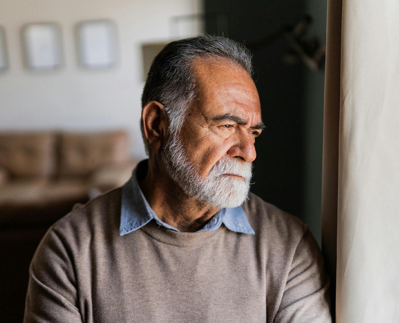 Older man looking out the window