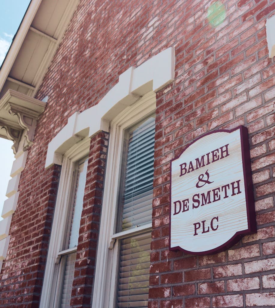 Bamieh & De Smeth PLC sign on the side of a brick building