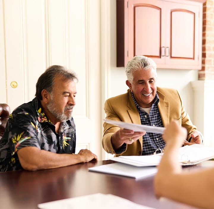 three people looking at paperwork