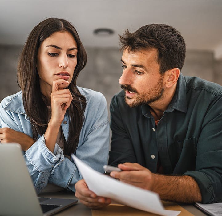 man and woman looking at documents