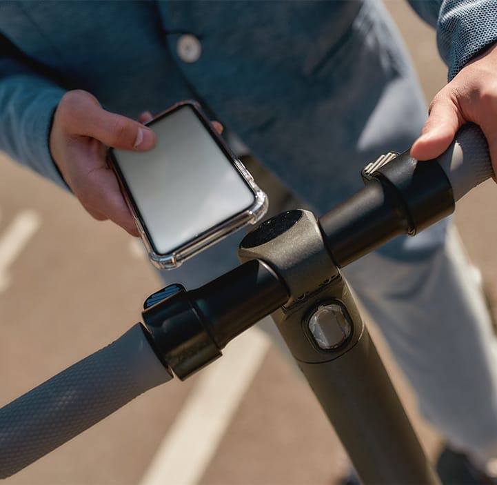 person on an e-bike with their phone