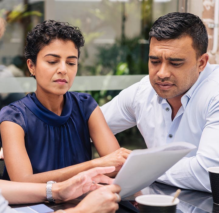 two people looking at paperwork