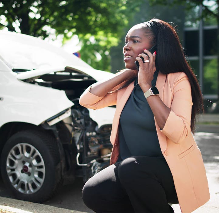 woman on the phone after getting in a car accident