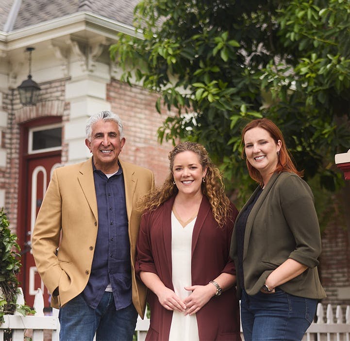 three attorneys smiling together