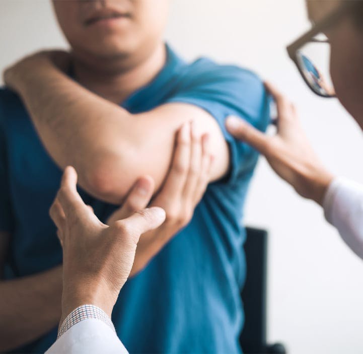 doctor looking at a man's arm