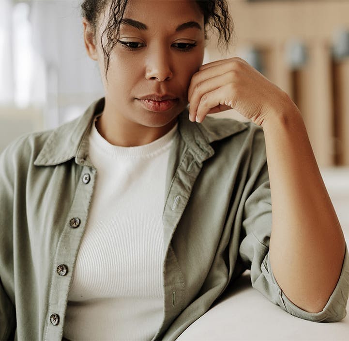 sad woman leaning on a table