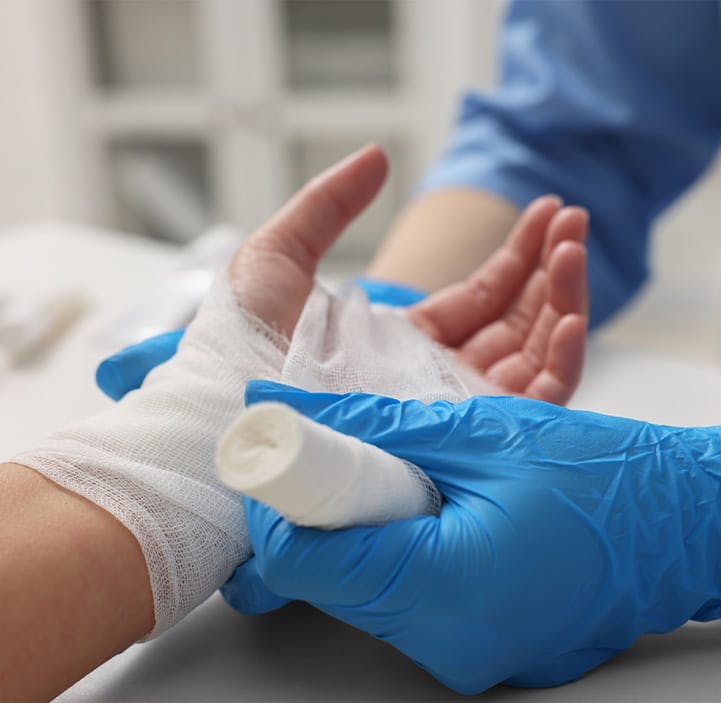 doctor wrapping a patient's hand in gauze