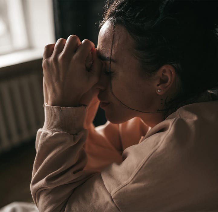 woman with her head in her hands