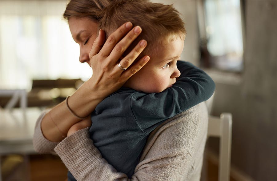 woman hugging a two year old boy