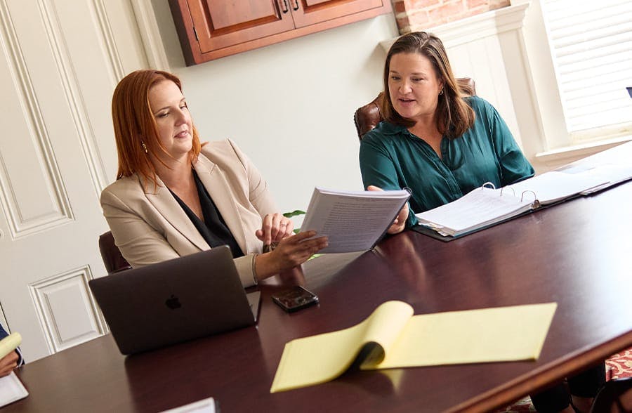 two women looking at paperwork