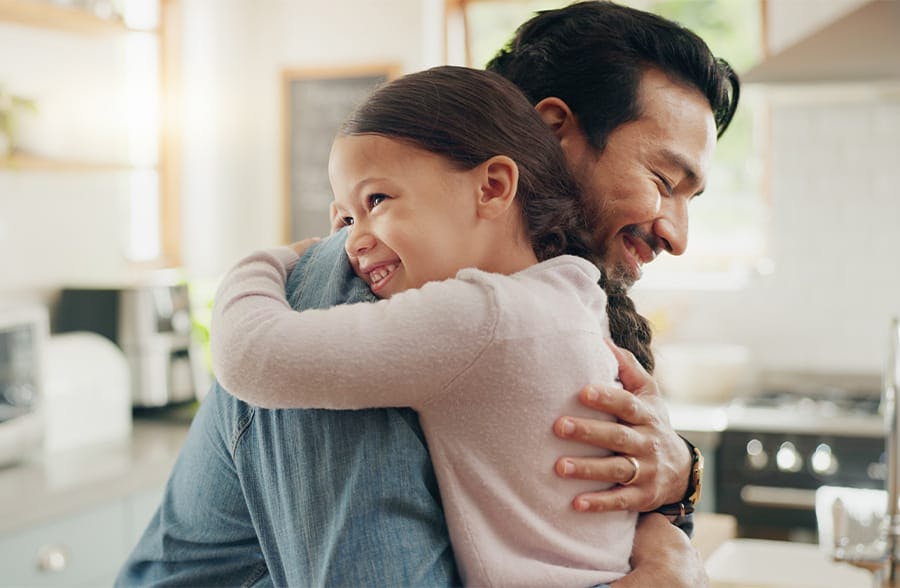 man hugging a five your old child