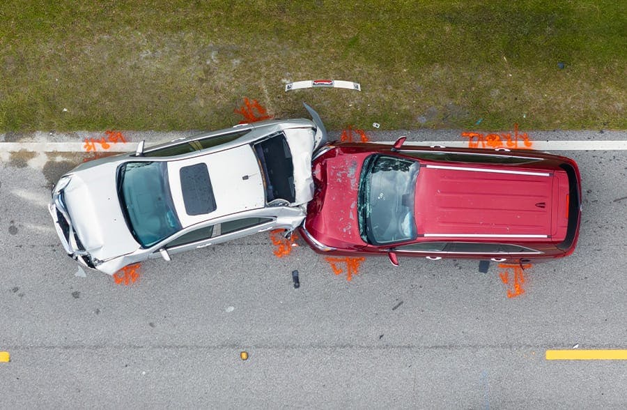 silver car rear ended by a red car