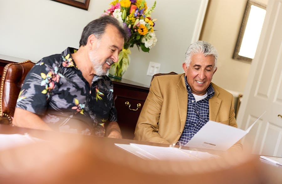 two older men looking at paperwork