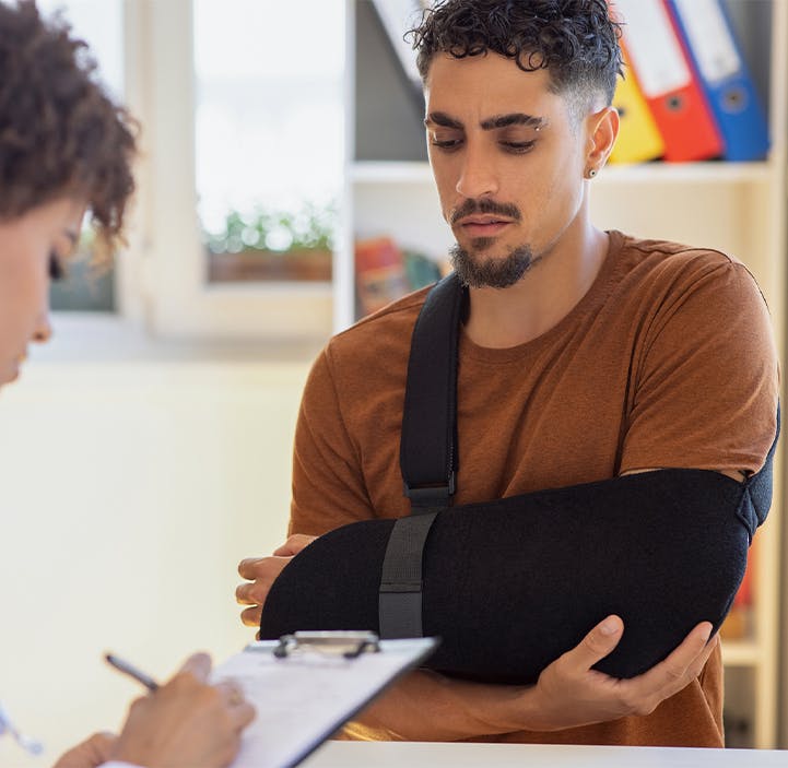 man with an arm cast and woman writing on a clipboard
