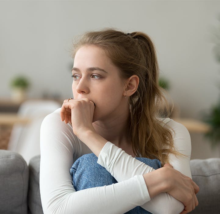 woman hugging her knees