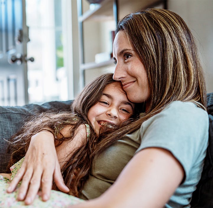 woman hugging a child