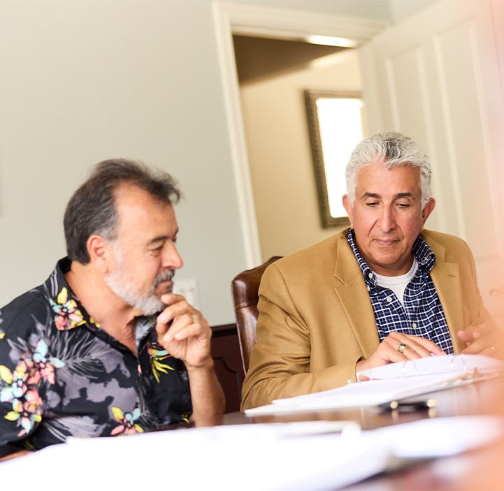 two older men looking at paperwork